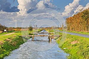 Typical Dutch flat polder landscape with cana and bridges