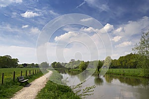 Typical Dutch landscape with river Kromme Rijn, walkway, clouds and trees photo