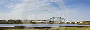 Typical Dutch river IJssel landscape with blue sky, white clouds, wind and sunny weather
