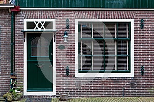 Typical dutch rural front door and window. Vintage European village house facade. Beautiful retro entrance doors Netherlands