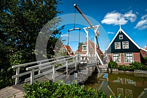 Typical dutch white wooden drawbridge. Architecture for over channels, ditches or rivers in old villages or cities