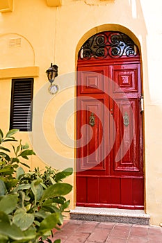 Typical elegant red door in Maltese villages