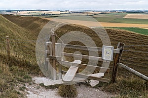 Typical english country stile with dog gate leading to meadow Maiden Castle Dorset Dorchester United Kingdom