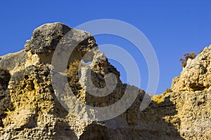 Typical exposed sedimentary sand stone cliff face on the Praia da Oura beach in Albuferia