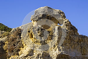 Typical exposed sedimentary sand stone cliff face on the Praia da Oura beach in Albuferia