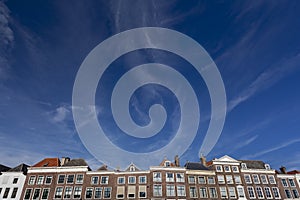 Typical facades of historic Middelburg in The Netherlands against a blue sky