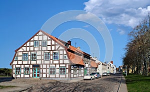 Typical fachwerk house of old Klaipeda, Lithuania medieval town and cobbled pavement street. German style buildings of