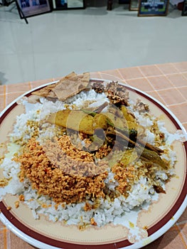 A typical family dinner.contains potato curry and sambol.