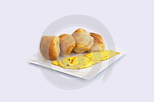 Typical Filipino Breakfast, Pandesal Crusted Bread and Scrambled Egg on a plate. photo