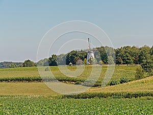 Typical flemish ardennes farmscape with historic windmill