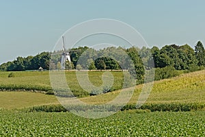 Typical flemish ardennes farmscape with historic windmill