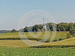 Typical flemish ardennes farmscape with historic windmill photo