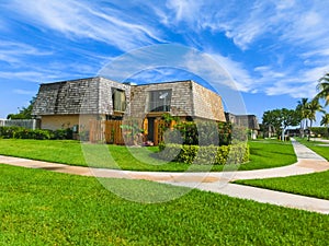 Typical Florida home in the countryside with palm trees, tropical plants and flowers