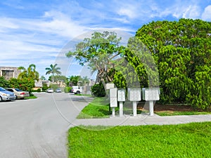 Typical Florida home in the countryside with palm trees, tropical plants and flowers