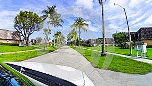 Typical Florida home in the countryside with palm trees, tropical plants and flowers