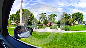 Typical Florida home in the countryside with palm trees, tropical plants and flowers