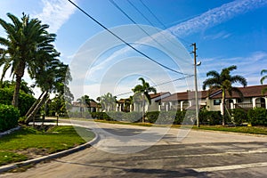 Typical Florida home in the countryside with palm trees, tropical plants and flowers