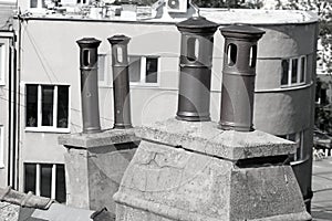 Typical four old metallic pipes on a tiled roof in european city, Bratislava, Slovakia. Black and white