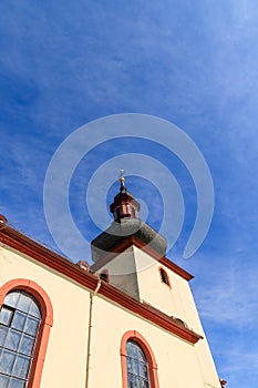 Typical german catholic church tower in front of blue sky in Nierstein, Rheinhessen