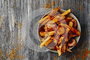 typical german currywurst and chips in a plate