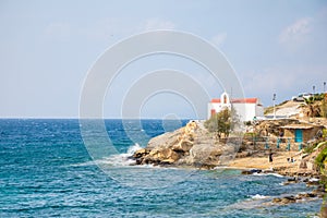 Typical Greek church white building with red dome against the blue sky on the island Mykonos, Greece