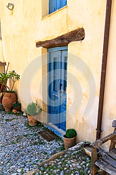 Typical Greek, mediterranean house entrance with blue wooden door. Crete, Greece