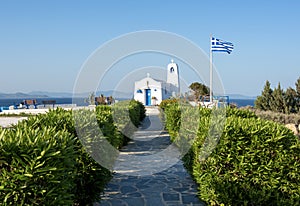 Typical greek place with a white small orthodox chapel dedicated