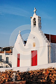 Typical Greek white church with red doors at Mykonos Town, GREECE