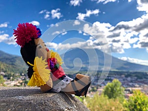 Typical Guatemalan handmade doll and Agua volcano on the background