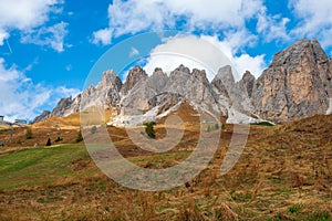 Typical hilly mountain landscape in the Dolomites with beautiful autumn colors on a foggy morning near the town of Cortina dâ€™