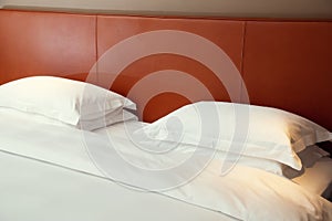 Typical hotel room. Double bed with white linen, two pillows