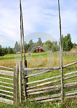 Typical house behind a wooden fence in a village in Leksand, Sweden photo