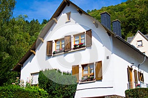 Typical house of Vianden in Luxembourg, with colorful flowers in the windows