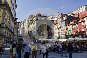 Typical houses and outdoor cafes at historic Ribeira Square of Porto