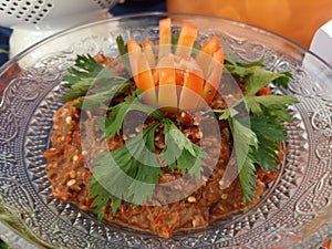 Typical Indonesian Chili Sembel garnished with celery leaves and tomato slices