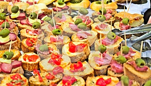 Aperitif buffet with appetizers and bruschetta with tomatoes, olives, sauces and salami