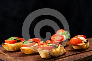 Typical Italian bruschetta or Spanish tapa with cherry tomato, basil and Philadelphia type spreadable cheese. Mediterranean food
