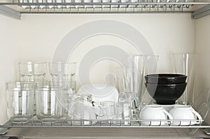 Typical italian dinnerware cabinet with glasses and bowls for different beverages and foods