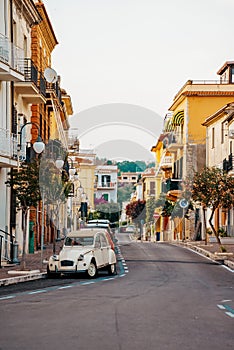 Typical italian street with old car