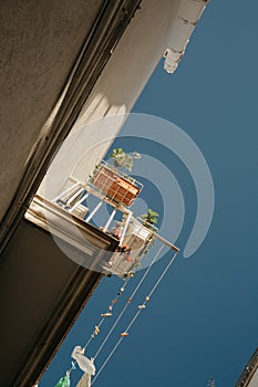 Typical Italian Street in Ostuni with a Balcony and Blue Sky Background