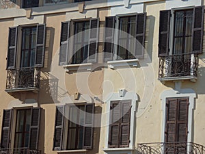 Typical Italian style building with brown shutters