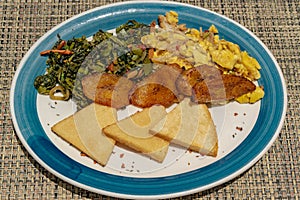 Fried bammy, friend plantain, ackee and sailfish, callaloo photo