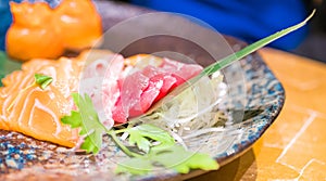 Typical Japanese dish of sushi, rice and fish, with sauce, salad, sushimi and sesame