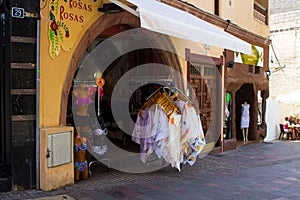 A typical ladies fashion shop with street displays and inviting archway entrance in the Spanish island of Teneriffe in the Canarys