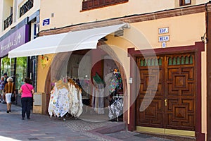 A typical ladies fashion shop with street displays and inviting archway entrance in the Spanish island of Teneriffe in the Canarys