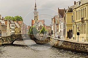 Typical landscape of a canal with its bridge in the middle of the medieval city of Bruges. Belgium