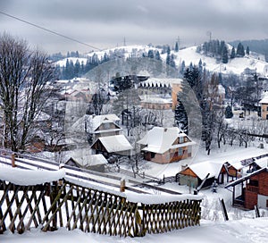 Typical landscape of the Ukrainian Carpathians with private estates in winter