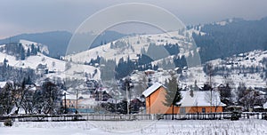 Typical landscape of the Ukrainian Carpathians with private estates in winter