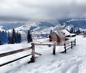 Typical landscape of the Ukrainian Carpathians with private estates in winter