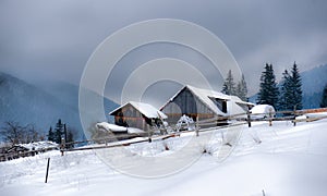 Typical landscape of the Ukrainian Carpathians with private estates in winter